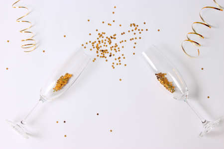 glasses and confetti on a colored background top view.の写真素材