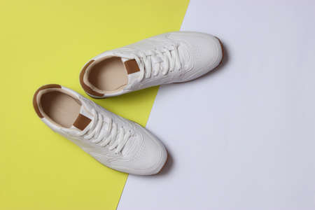 mens sneakers on a colored background top view. mens footwear. minimalism