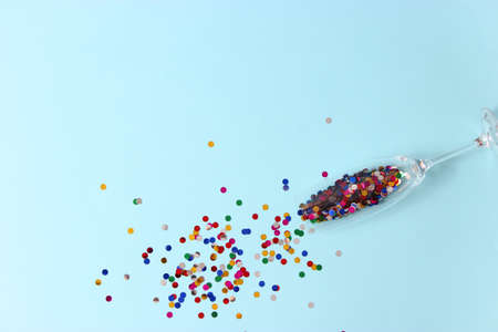 glasses and confetti on a colored background top view.の写真素材