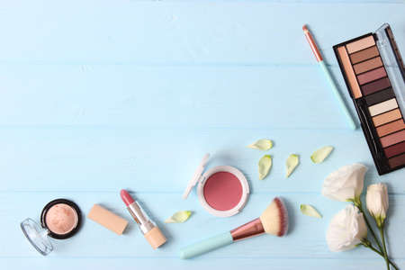 cosmetics and flowers on a colored background top view.の写真素材