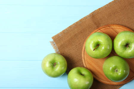 juicy green apples on a wooden table.の写真素材