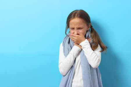 Portrait of a cold girl on a colored backgroundの写真素材