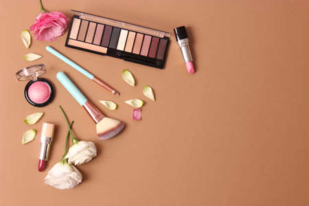cosmetics and flowers on a colored background top view.の写真素材