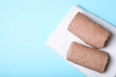 Fresh towels on a colored background with place for text top view.の写真素材