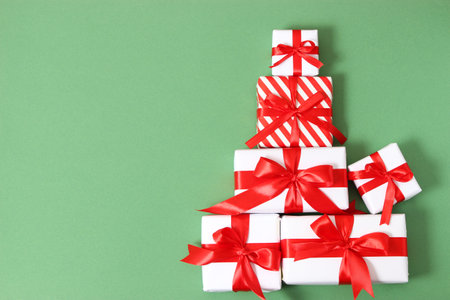 Set of beautifully wrapped gift boxes on a colored background top view.