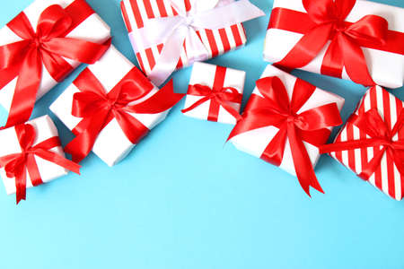 Set of beautifully wrapped gift boxes on a colored background top view.の写真素材