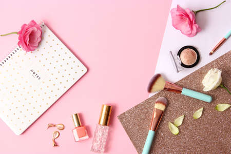 cosmetics and flowers on a colored background top view.の写真素材