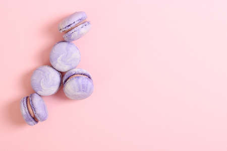 macaroons on a colored background top view.