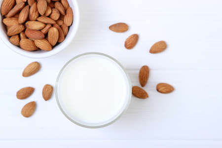 Almond milk and almonds on the table. Vegetable milk. Vegetarian milk.の写真素材