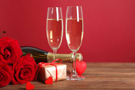 Champagne, flowers and gifts on the table. Valentines day background.の写真素材