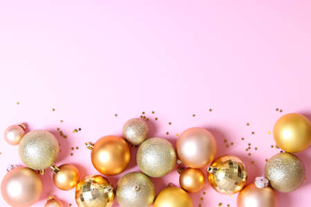 Decorative Christmas balls on a colored background top view.