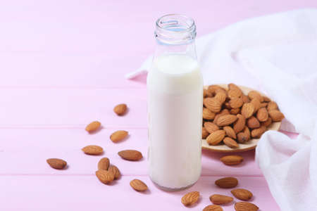 Almond milk and almonds on the table. Vegetable milk. Vegetarian milk.の写真素材