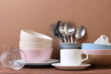 A set of dishes and kitchen utensils on a colored background.の写真素材