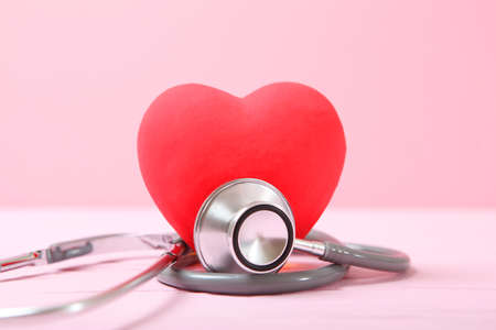 Stethoscope and heart on wooden background. Health, medicineの写真素材