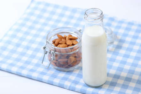Almond milk and almonds on the table. Vegetable milk. Vegetarian milk.の写真素材