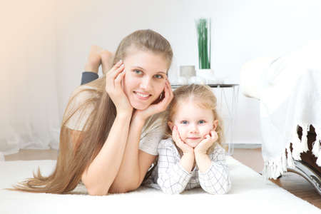 Mothers day concept. Mom and daughter at homeの写真素材