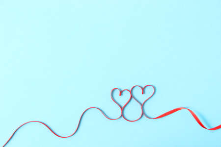 hearts from ribbons on a colored background top view.の写真素材
