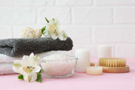 spa composition with towels and care products on the table with place for text.の写真素材