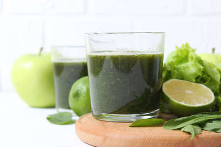 Green smoothie and fresh vegetables on the table for the detox organism