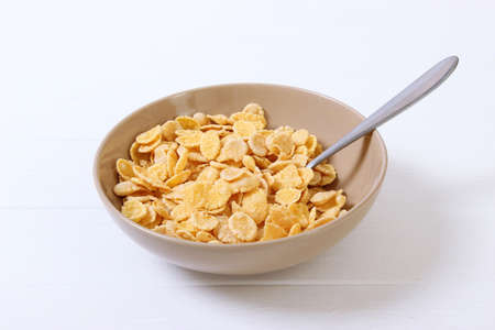 dry breakfast in a plate on a colored background top view. cereal