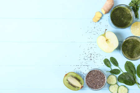 Green smoothie and fresh vegetables on the table for the detox organismの写真素材