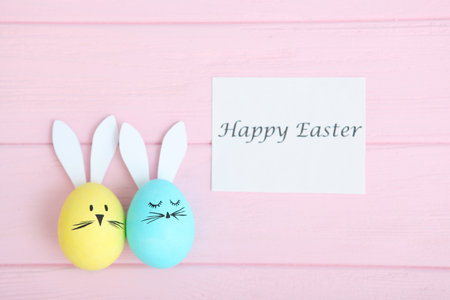 Easter eggs with cute faces and ears on a colored background.
