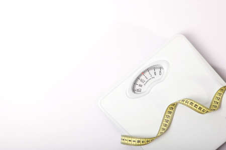 floor scales and tape measure on a colored background top view.の写真素材