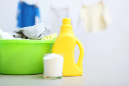 Baby clothes and detergents on the table. Baby clothes care concept.の写真素材