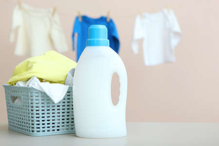 Baby clothes and detergents on the table. Baby clothes care concept.の写真素材