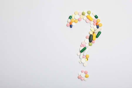 pills on a light background top view. Medicine, treatment, illness.の写真素材