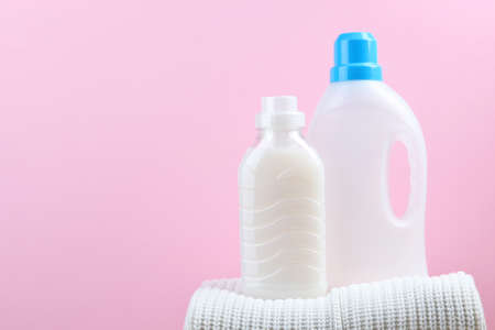 Laundry detergent bottles and clothes on the table. Household chemicalsの写真素材
