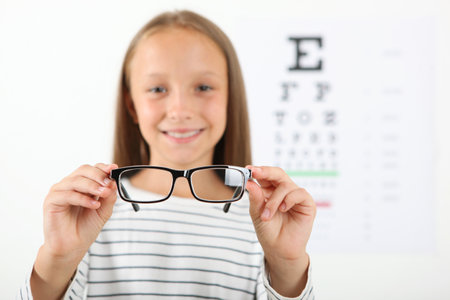 Cute little girl checks eyesight with an ophthalmologist. eyesight testの写真素材