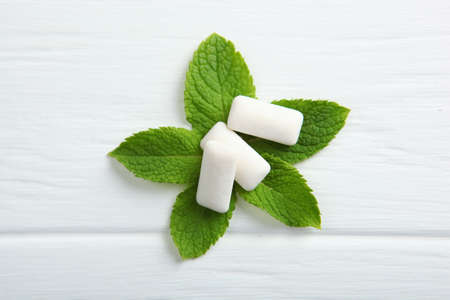 mint chewing gum and mint on the table. Fresh breath, oral care