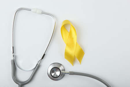 yellow ribbon symbolizing cancer in children top viewの写真素材