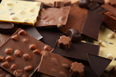 Chocolate of different types on a colored background with a place for textの写真素材