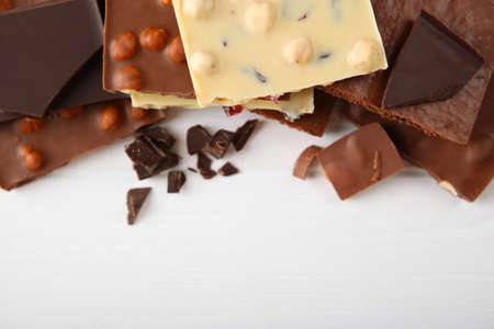 Chocolate of different types on a colored background with a place for text