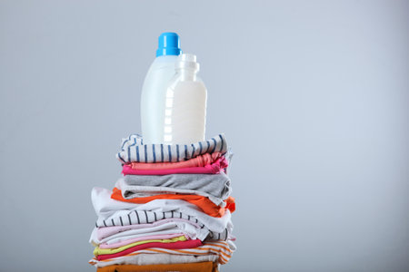 Laundry detergent bottles and clothes on the table. Household chemicalsの写真素材