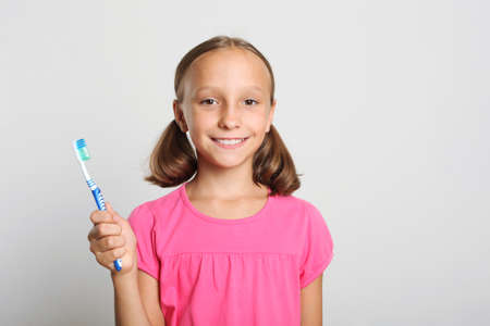 Little girl brushes her teeth. Dental care for childrenの写真素材