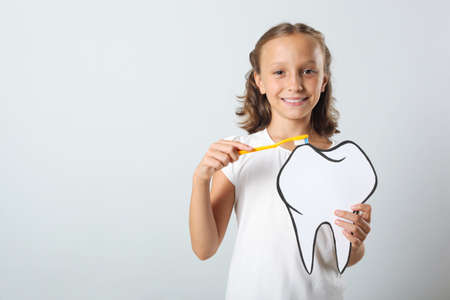 Little girl brushes her teeth. Dental care for childrenの写真素材