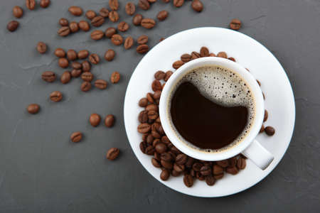 coffee beans and coffee cup on colored background with place for text. High quality photoの写真素材