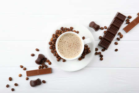 cup of coffee, coffee beans and chocolate on the table close upの写真素材