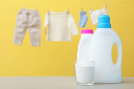 Baby clothes and detergents on the table. Baby clothes care concept.の写真素材