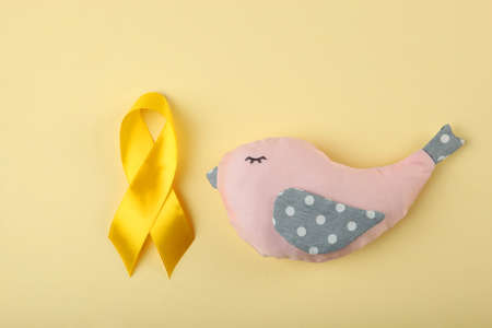 yellow ribbon symbolizing cancer in children top view