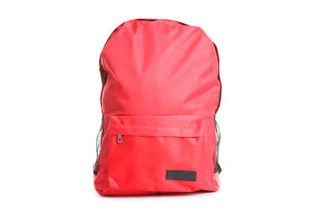 backpack and school stationery isolated on white
