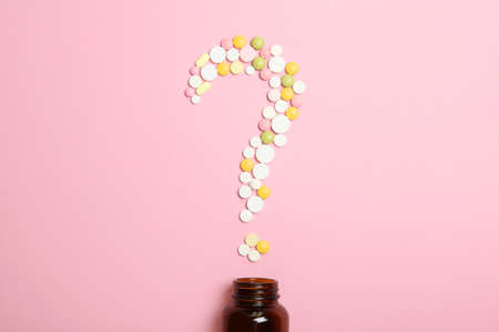 pills on a colored background top view. Medicine, treatment, illness.の写真素材