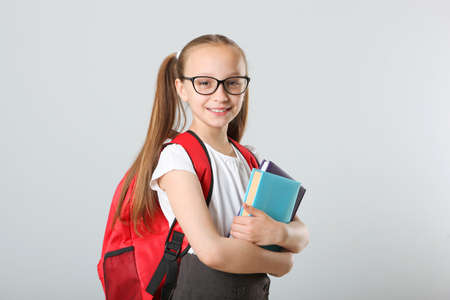 Portrait of schoolgirl with a backpack and stationery.の写真素材