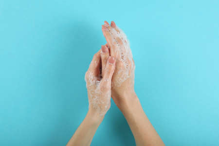 girl washes her hands with soap, hygiene and cleanliness of handsの写真素材
