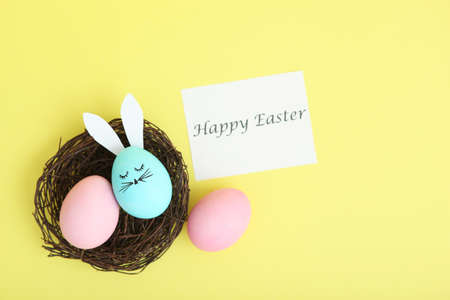 Easter eggs with cute faces and ears on a colored background.