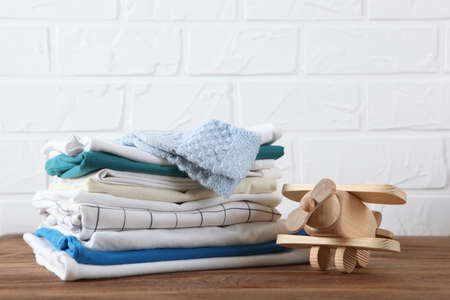 a stack of baby clothes on a light background.の写真素材