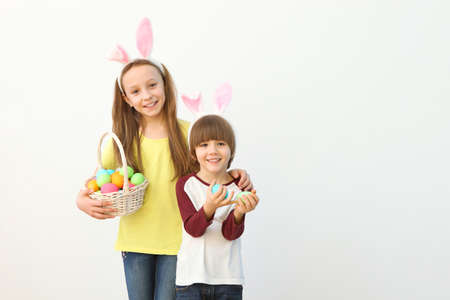 Cute little boy and girl in rabbit ears and with an Easter basket